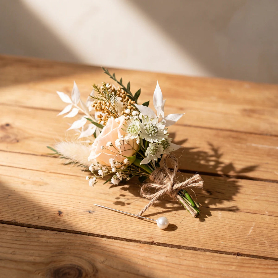 Rustic peach rose boutonniere with bunny tails, astrantia and jute twine on a pine table, Fabulous Flowers South Africa