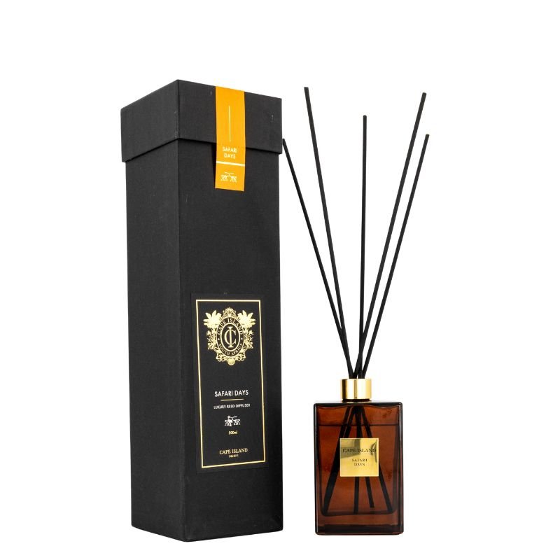 Reed diffuser set with black box and amber bottle on a white background