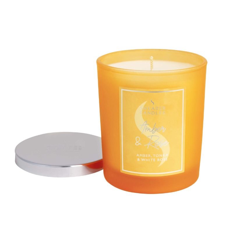 Orange candle with a label on a white background
