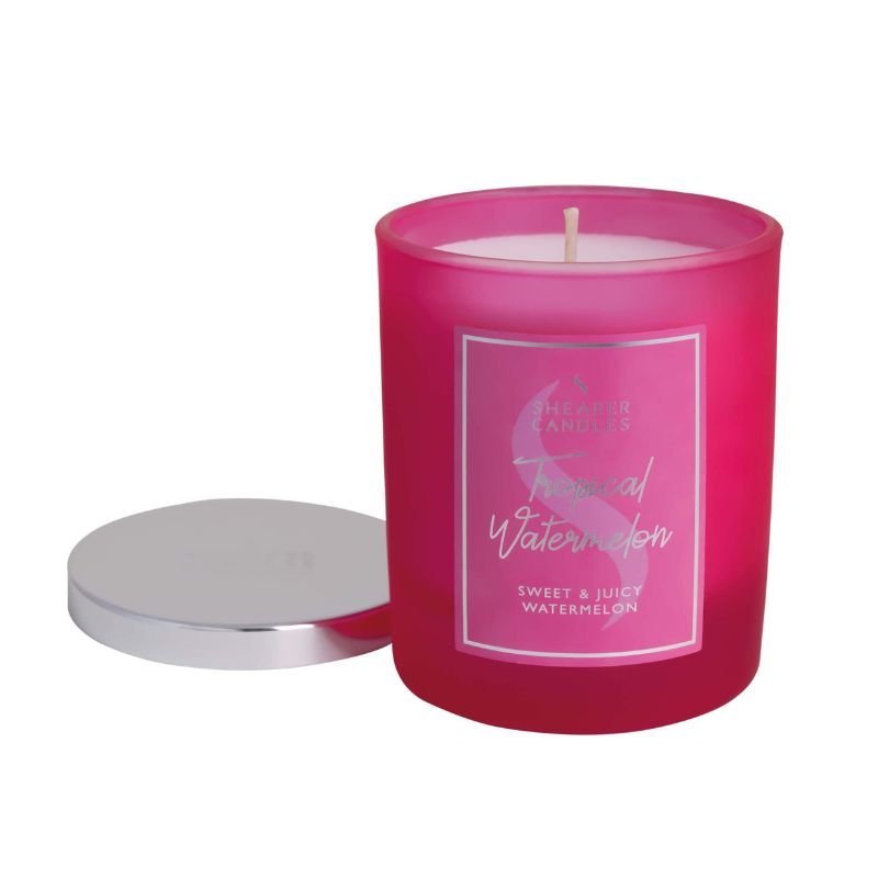 Pink candle with a label on a white background