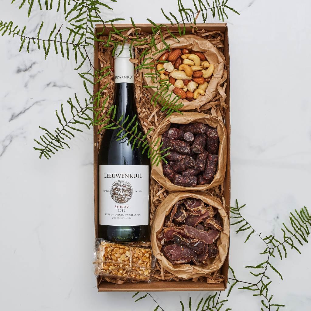 Simply Scrumptious Snack Gift Box packed with mixed nuts, biltong, droewors, peanut brittle and Leeuwenkuil Shiraz red wine - Fabulous Flowers