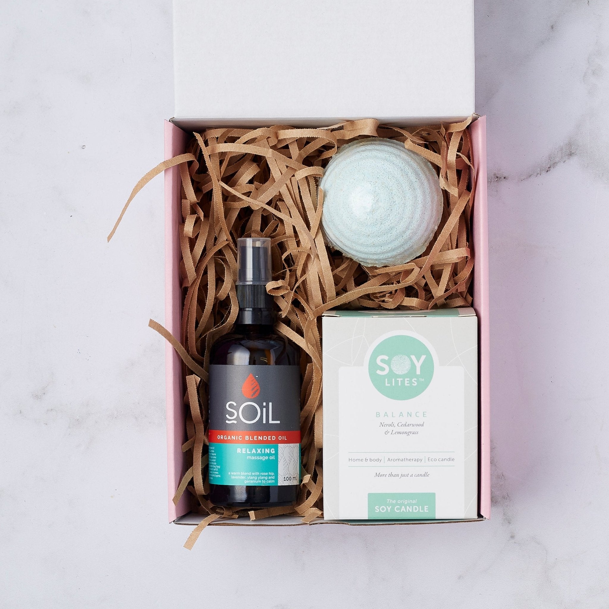 Soothing Balance Gift Set with organic relaxing massage oil, a balance soy candle, and a blue bath bomb in a beautifully presented box.