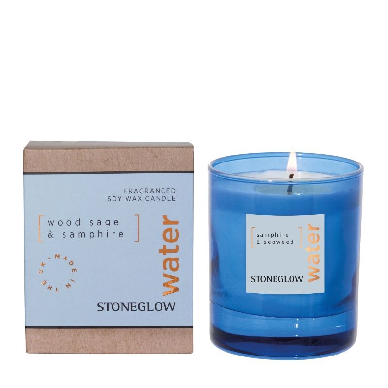 Blue candle with 'Stoneglow' label and packaging on a white background