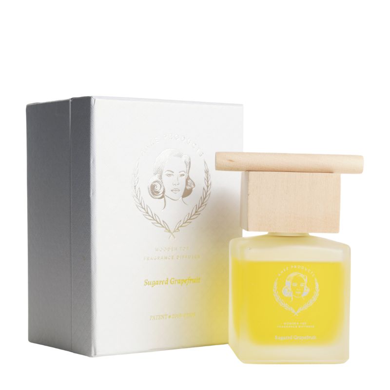 Yellow perfume bottle with wooden cap and white box on a white background