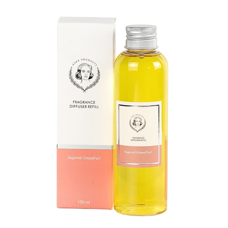 Fragrance diffuser refill bottle with packaging on a white background