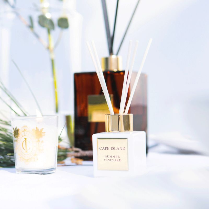 Cape Island Summer Vineyard diffuser with a candle and decorative elements on a light background