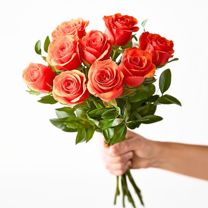 10 orange roses bouquet with lush greenery, held in hand — Fabulous Flowers & Gifts, Cape Town.