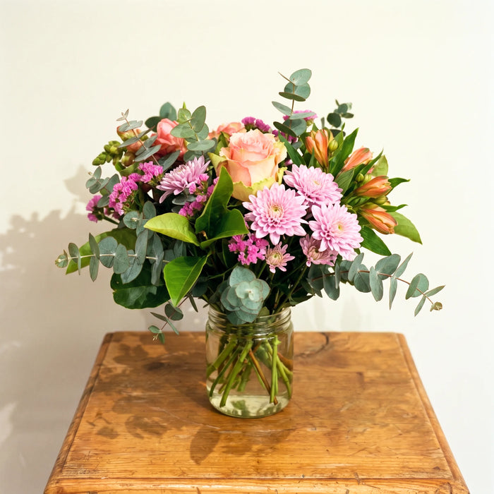 Sweet Pea in a Jar peach roses, pink chrysanthemums, statice and eucalyptus posy in a glass jar by Fabulous Flowers