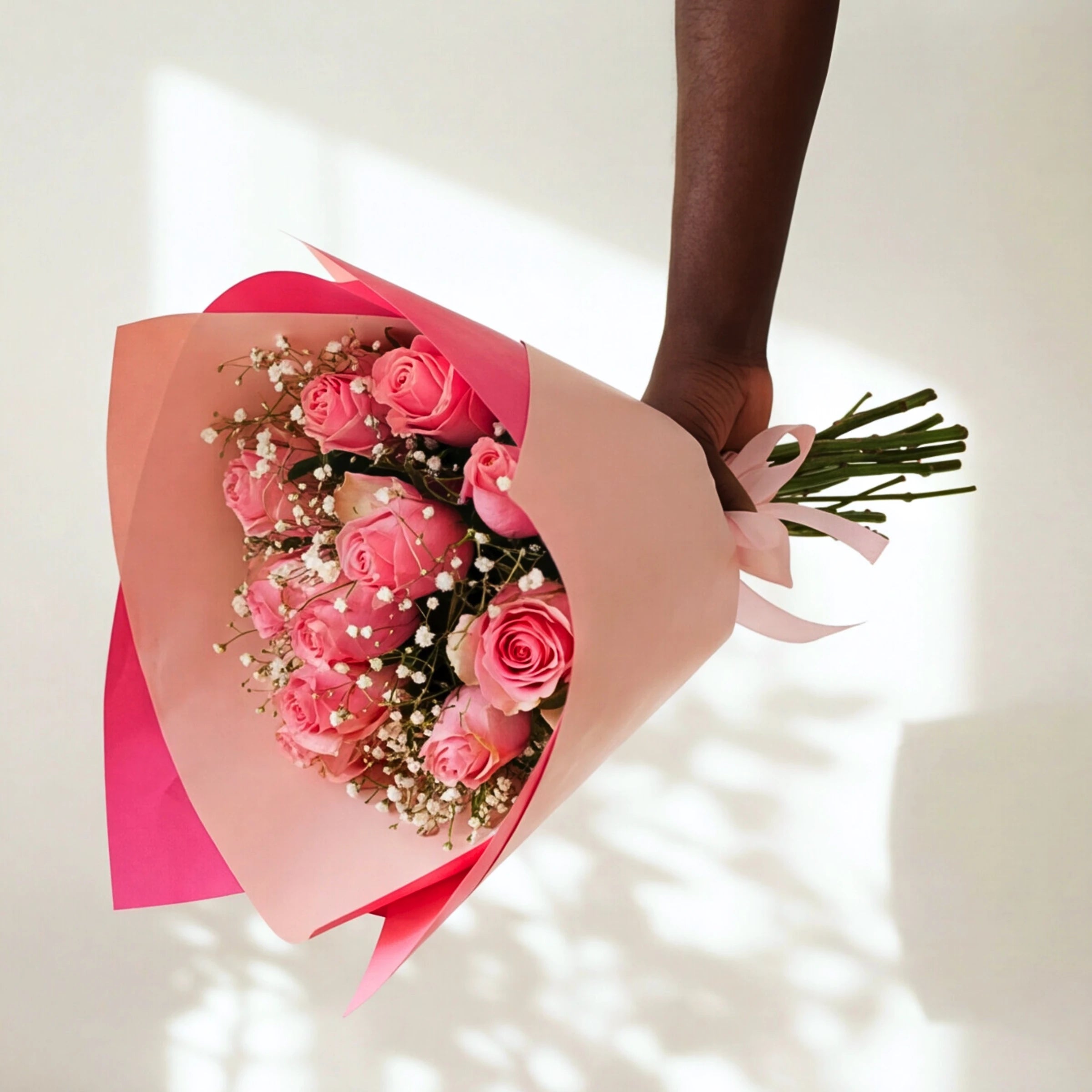 Sweet Talk bouquet of soft pink roses with white gypsophila, wrapped in pink paper with a pink ribbon