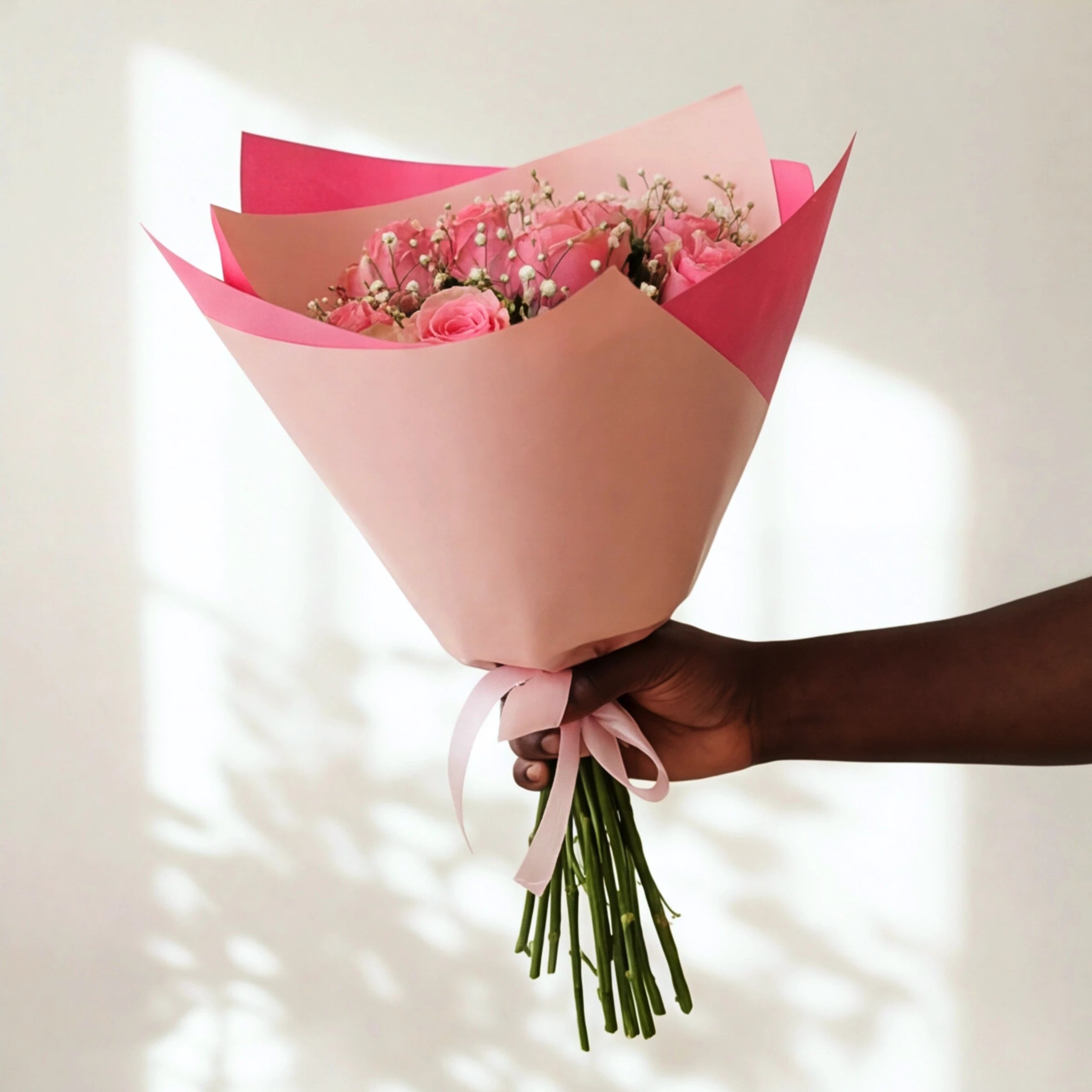 The Sweet Talk soft pink rose bouquet wrapped in pink paper with a pink satin bow