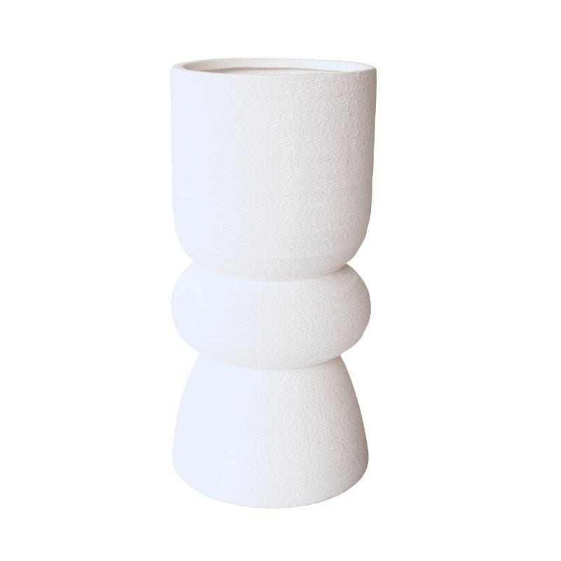 White ceramic vase with stacked design on a white background