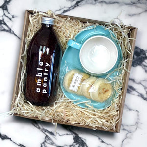 Photo of tea gift box with tea, biscuits, cup and saucer - Fabulous Flowers