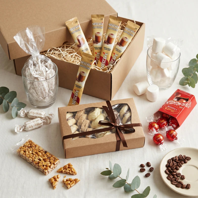 The Coffee Break Box styled with Nescafé Cappuccino sachets, Sally Williams Macadamia Nougat, peanut brittle, marshmallows, ribboned florentine selection, Lindt Lindor truffles and coffee beans, Fabulous Flowers and Gifts