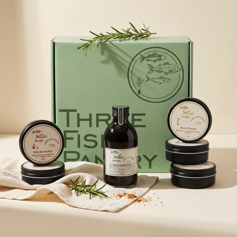 The Fish Pantry Home Cook overhead with five Three Fish Pantry rubs and Worcestershire sauce in the branded box, Fabulous Flowers and Gifts