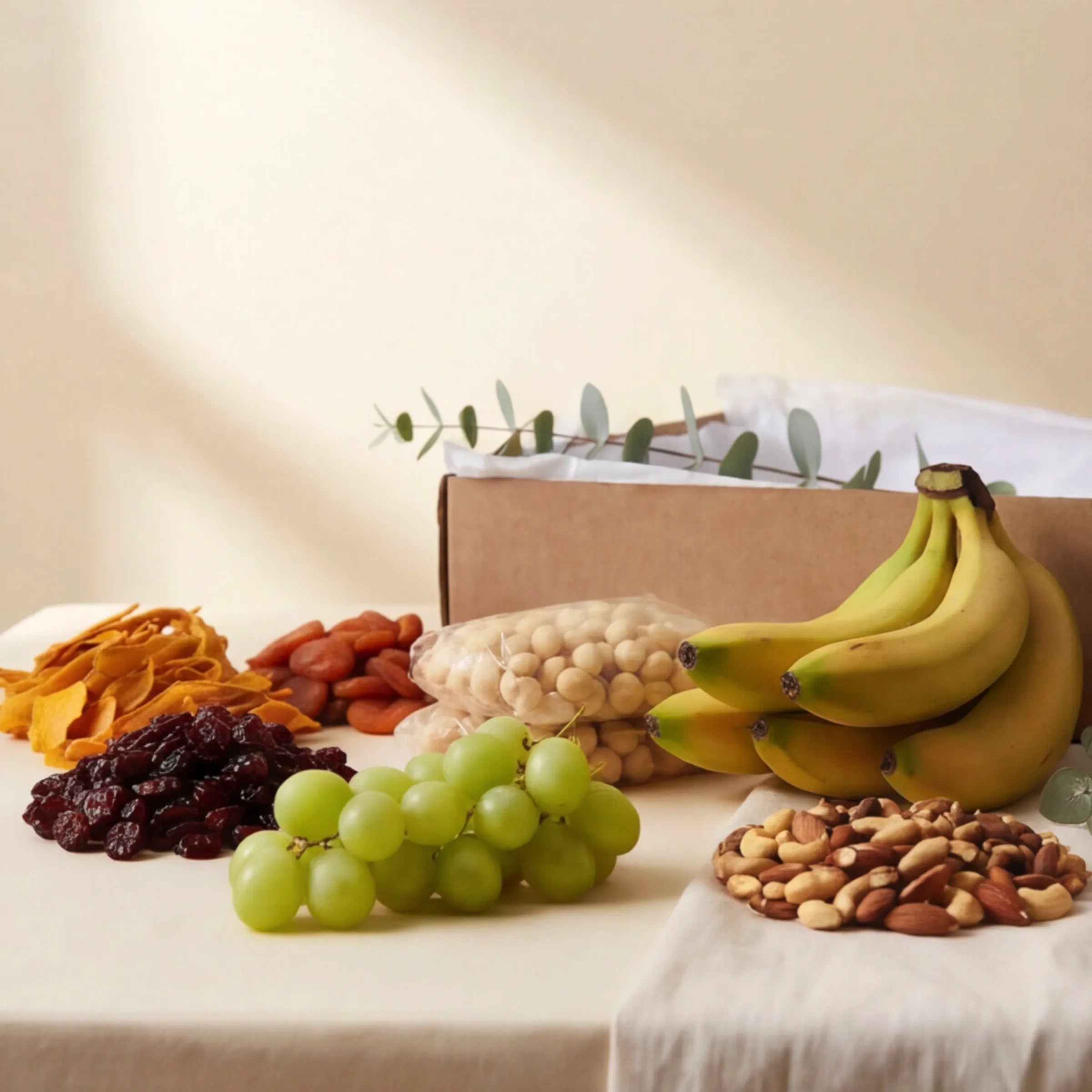 The Healthy Collection gift box from Fabulous Flowers South Africa, dried mango, apricots, cranberries, meeboos, chia seeds, macadamia nuts, mixed nuts, fresh bananas and green grapes packed in a kraft gift box, a healthy snack hamper for Cape Town same-day delivery