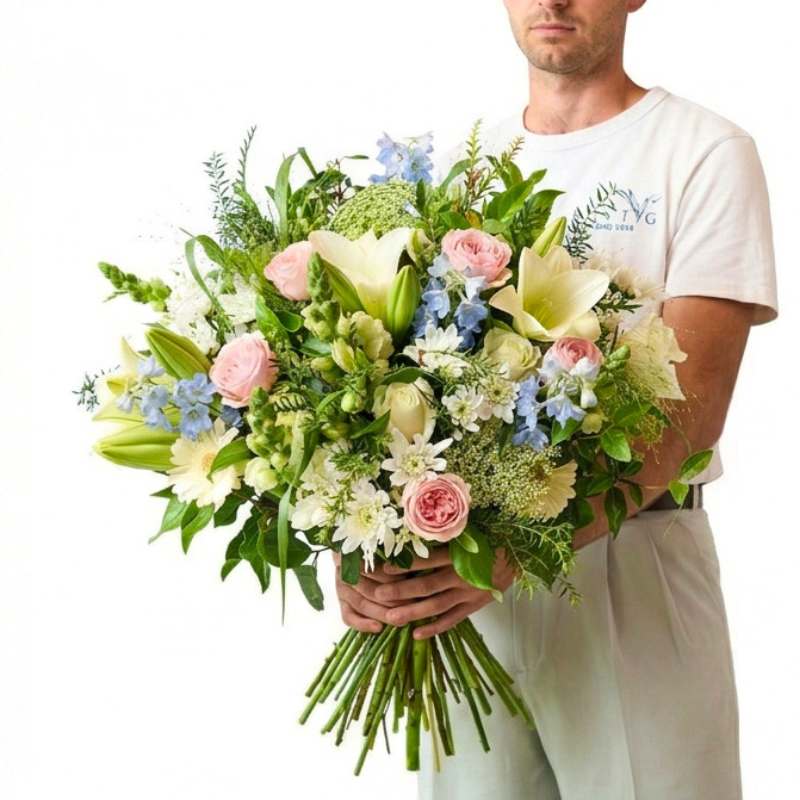 Person holding a large bouquet of flowers against a white background