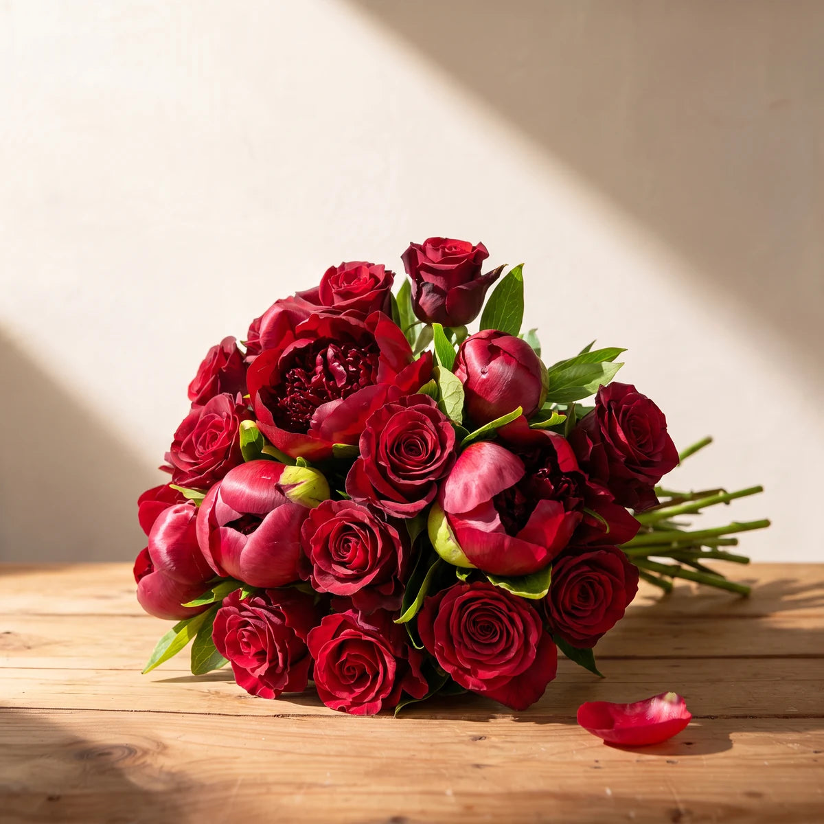 The Bloom Between Us bouquet of red peonies and red roses on a rustic pine table, Fabulous Flowers Cape Town
