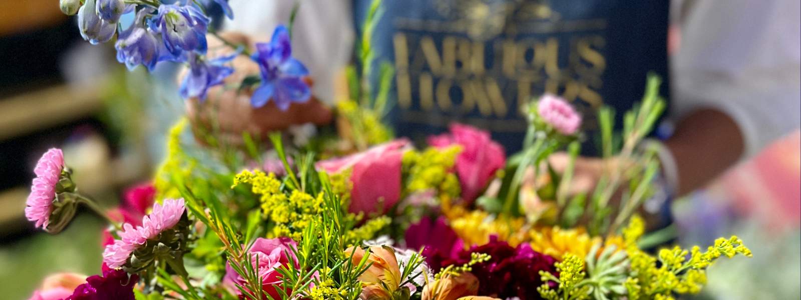 The Gold Standard of the Internet Florist Shop in South Africa, florist arranging flowers wearing apron