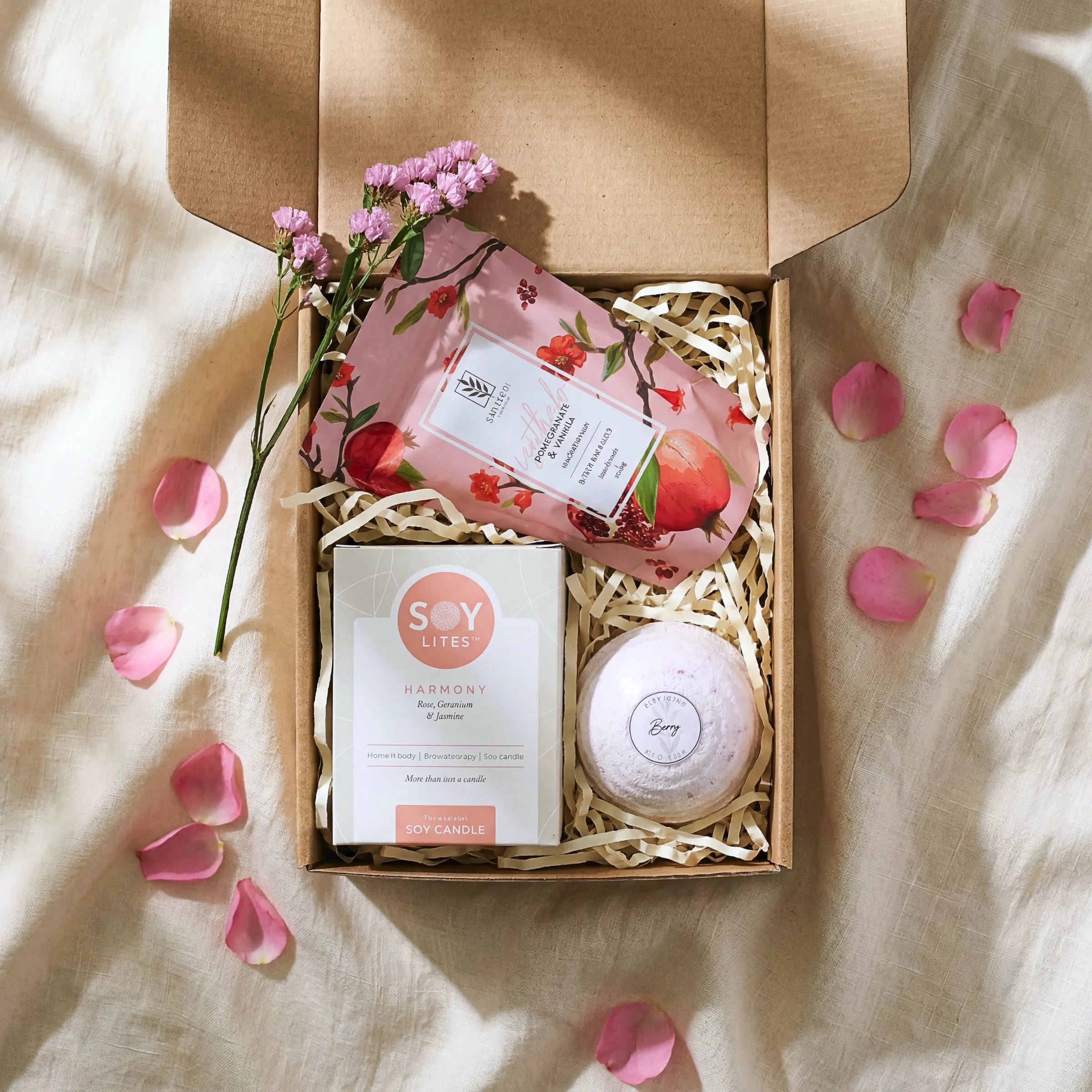 Top view of Tickle My Fancy Hamper open kraft box with Soy Lites Harmony soy candle, pomegranate vanilla bath salt and berry bath bomb