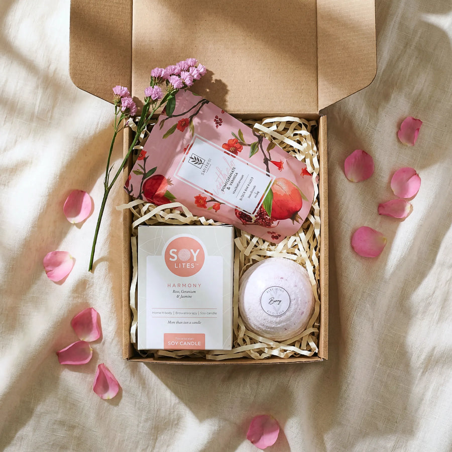 Top view of Tickle My Fancy Hamper open kraft box with Soy Lites Harmony soy candle, pomegranate vanilla bath salt and berry bath bomb
