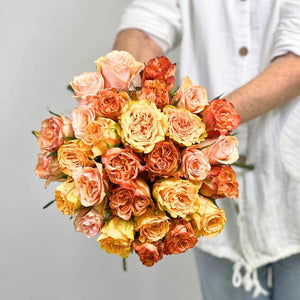 Close up of exquisite orange imported roses from Europe. Florist holding bouquet - Fabulous Flowers