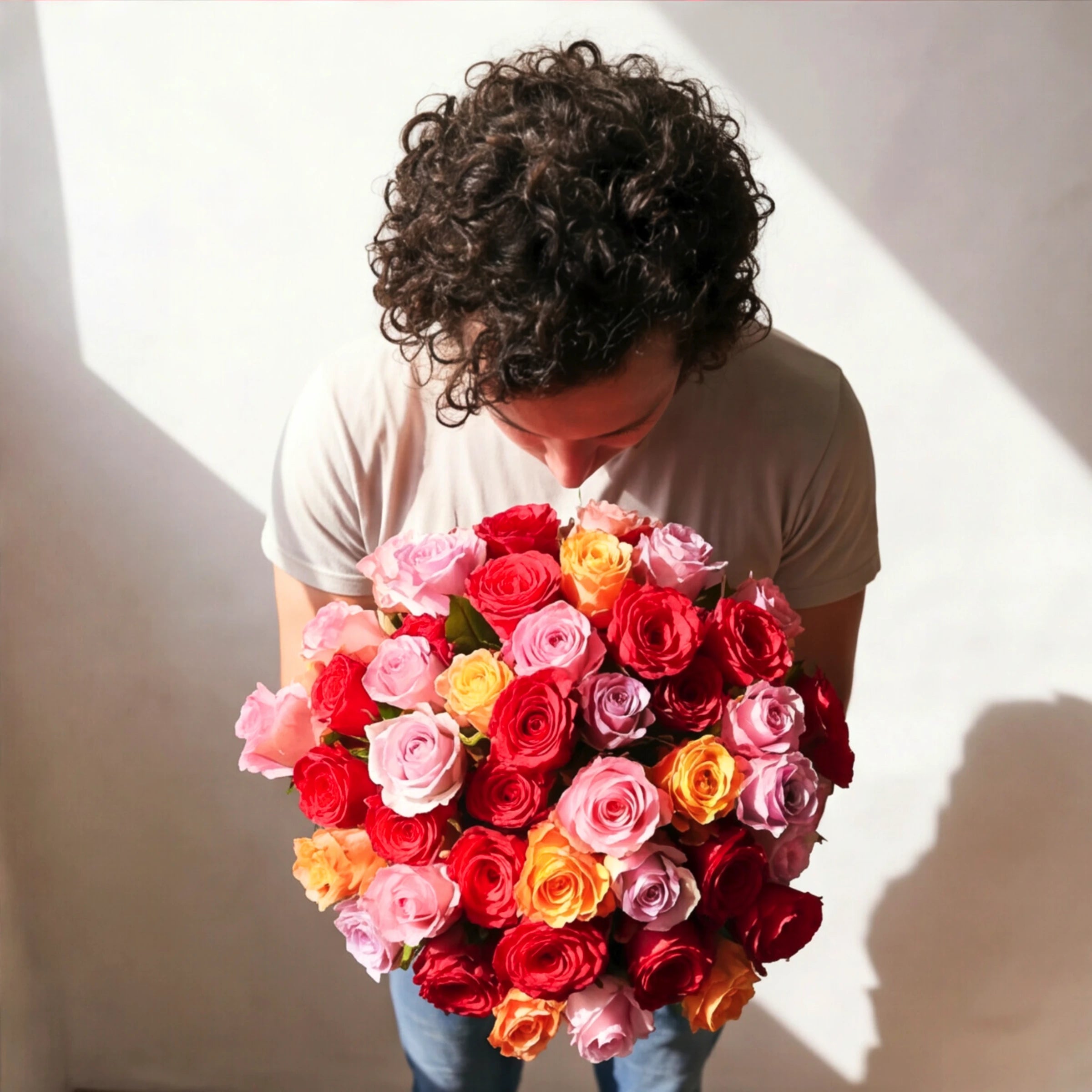 Top view of the Vibrant Rose Bouquet by Fabulous Flowers South Africa, multicoloured red, pink, lilac, orange and yellow roses hand-tied for milestone birthdays and anniversaries