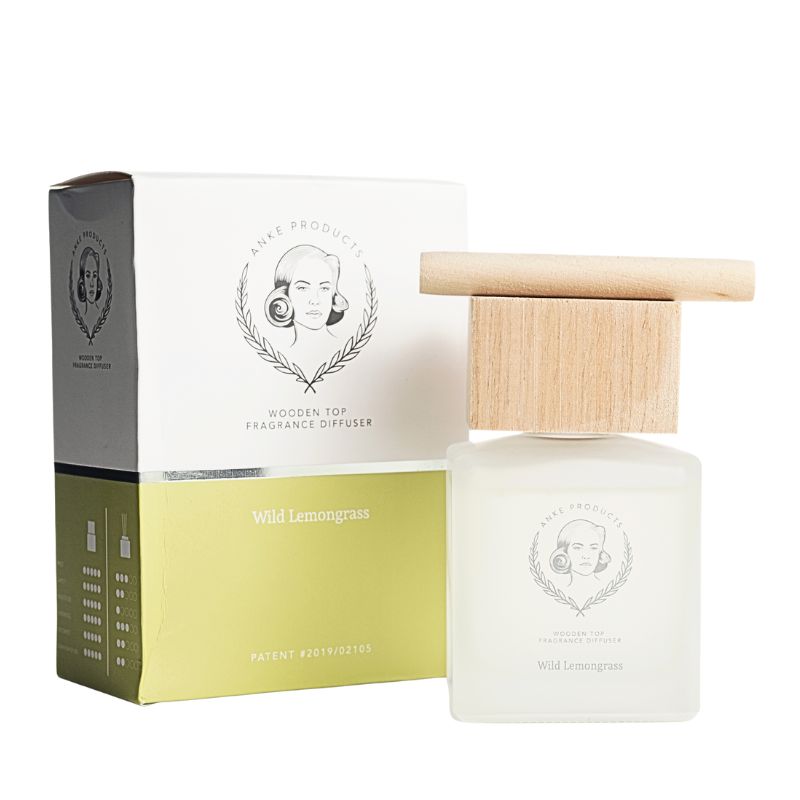 White wooden-top fragrance diffuser with packaging on a white background
