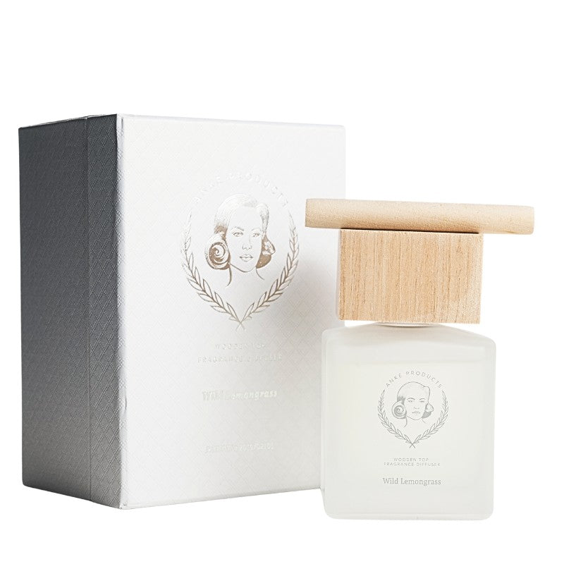 Perfume bottle with wooden cap and packaging on a white background