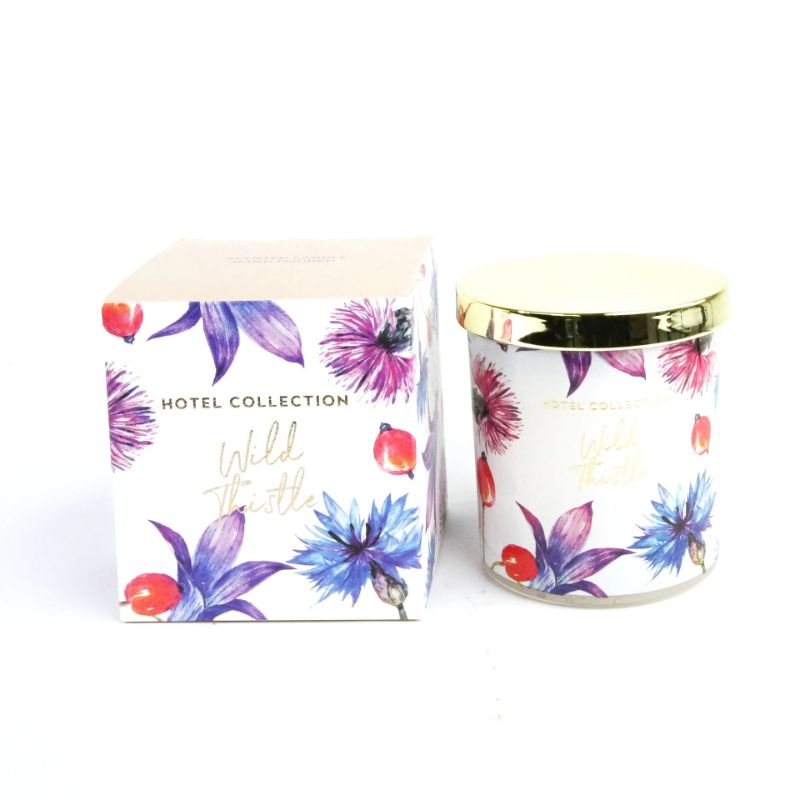 Floral-patterned candle and packaging with 'Hotel Collection' branding on a white background