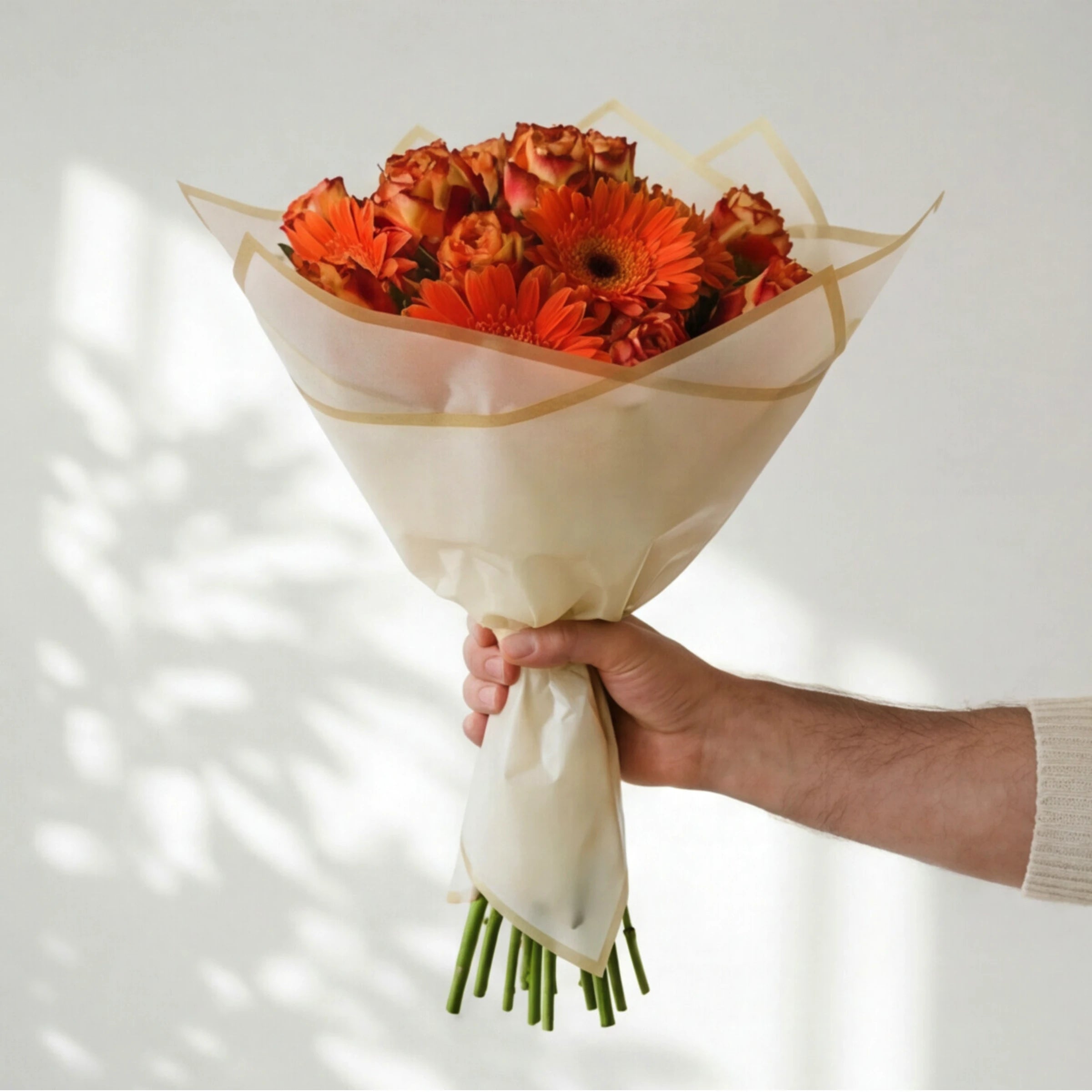 Wildfire bouquet wrapped in cream and gold, orange gerberas and flame roses, hand-tied by Fabulous Flowers since 1999