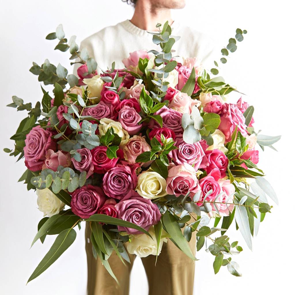 large bouquet of flowers, pink roses, man holding fresh flowers