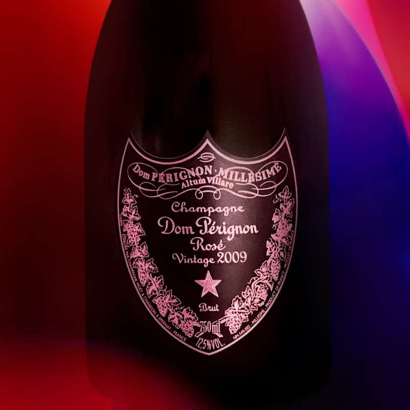 Dom Perignon champagne bottle with a pink label on a colorful background