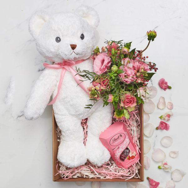 Baby Girl Gift Box with Lindor choclates, a small flower arrangement and a teddy bear - Fabulous Flowers Cape Town Flower Delivery