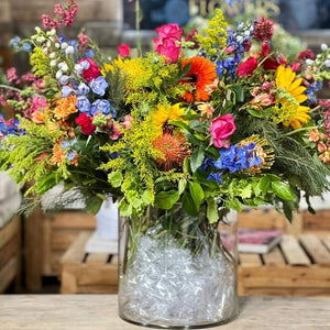 Vibrant flower arrangement with pincushions, golden rod, delphinium, gerberas, sunflowers and roses - Fabulous Flowers