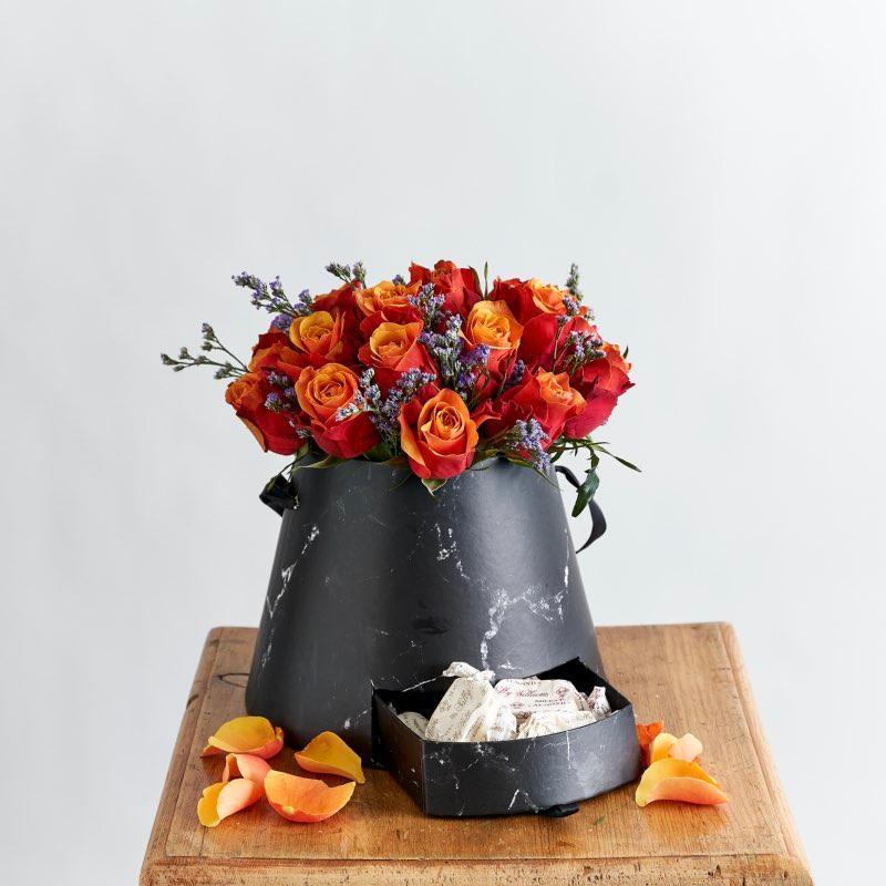Cherry Brandy Orange rose flower arrangement in a black box with nougat - Fabulous Flowers