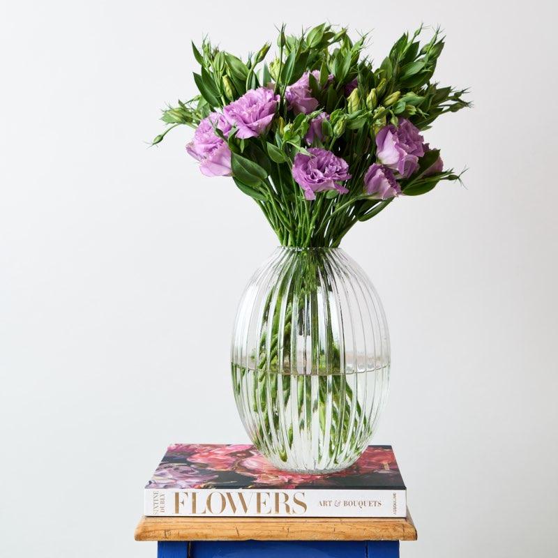 Eternal Grace is a gorgeous and elegant arrangement in a striking glass vase that reminds us of another period, classic addition to your vase collection. This beautiful arrangement of purple Lisianthus and candle from Fabulous Flowers and Gifts.