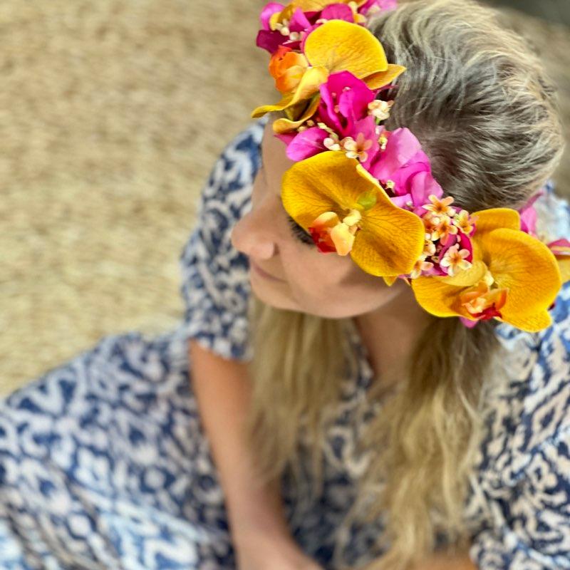 Detail of a silk flower crown with pink bougainvillea, orchids and blossoms created by Fabulous Flowers. 