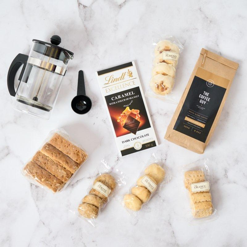 The Plunge into Happiness gift hamper includes:  The Coffee Guy medium roast house blend coffee 250g Lindt Excellence Caramel Dark Chocolate Fabulous Rusks Coffee plunger Luxury biscuits delivered by Fabulous Flowers same day or via courier.