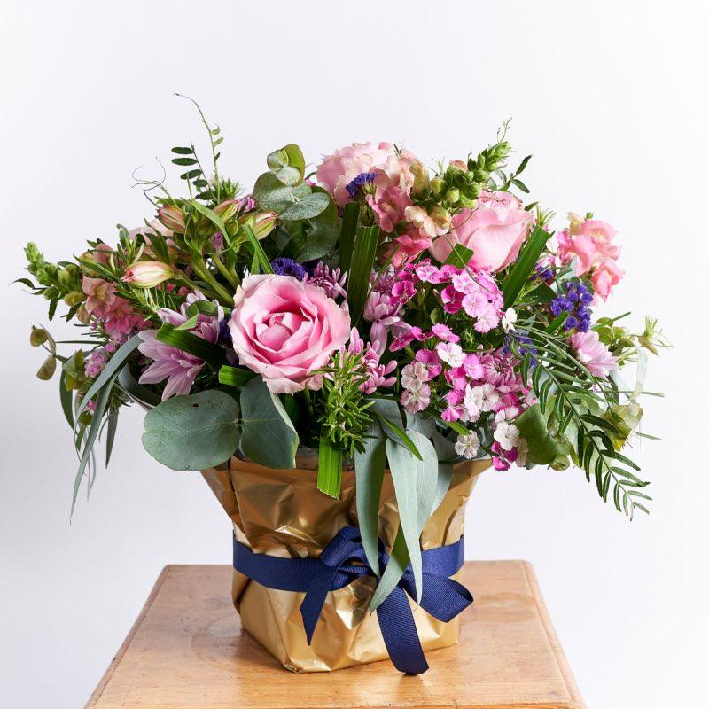 Flower arrangement with Alstromeria, pink roses,  purple statice, pink snapdragons, sweet william and wild greenery