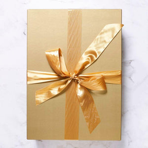 Golden wrapped gift box with gold ribbon | Fabulous Flowers gift delivery