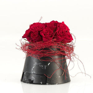 Red roses in a faux-marble container and red twine - Fabulous Flowers
