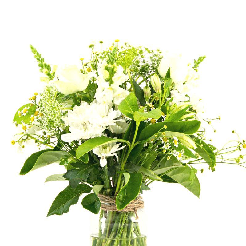 White flowers with greenery arranged in a glass jar.