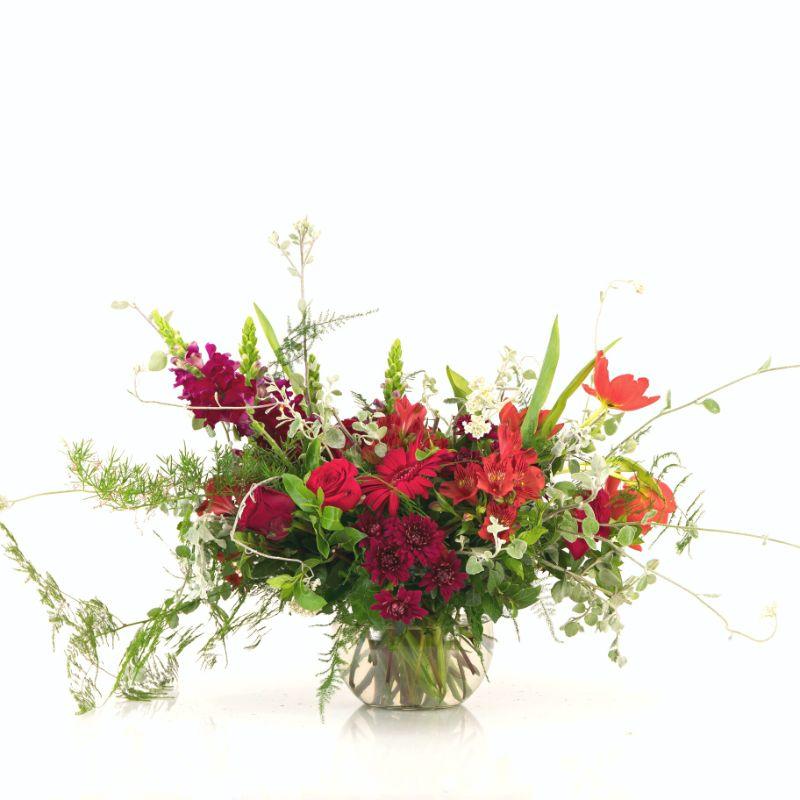 Red flower round vase arrangement with red roses, greenery and tulips delivered to the people you love in Cape Town by Fabulous Flowers