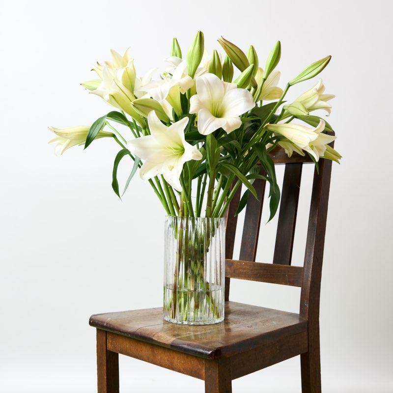 Open St Joseph lilies in a beautiful glass vase - Fabulous Flowers