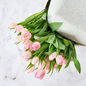 Close up of the exquisite pink tulips arranged in an expensive luxury beaded box from Bail. Order today for same day gift delivery by Fabulous Flowers. 