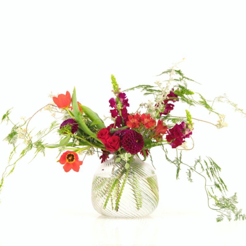 Decorative vase arrangement containing red flowers including rose, dahlias and tulips from Fabulous Flowers. 