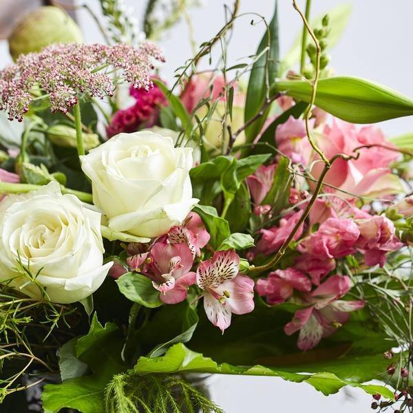 Enchanted Beauty Flower Arrangement with white roses and pink alstroemeria, lace and lilies.